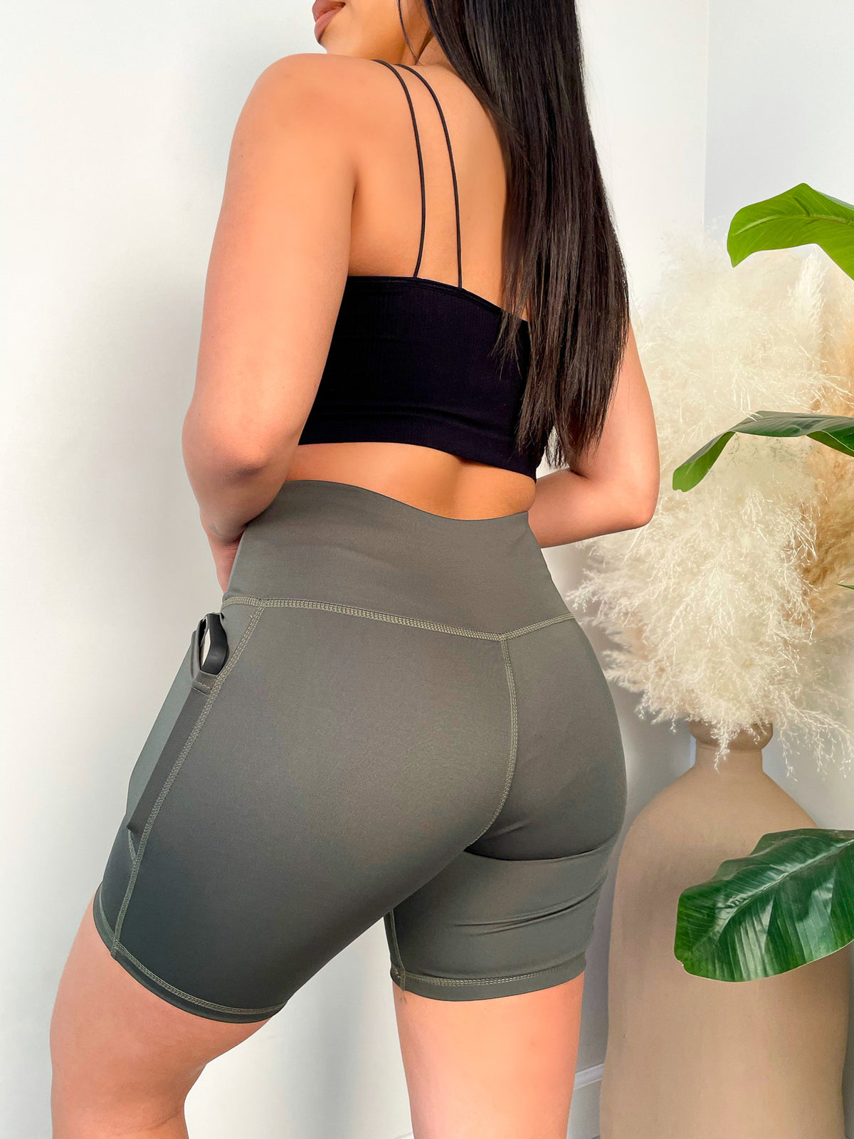 olive shorts, high waisted, mid thigh length, small side pockets 