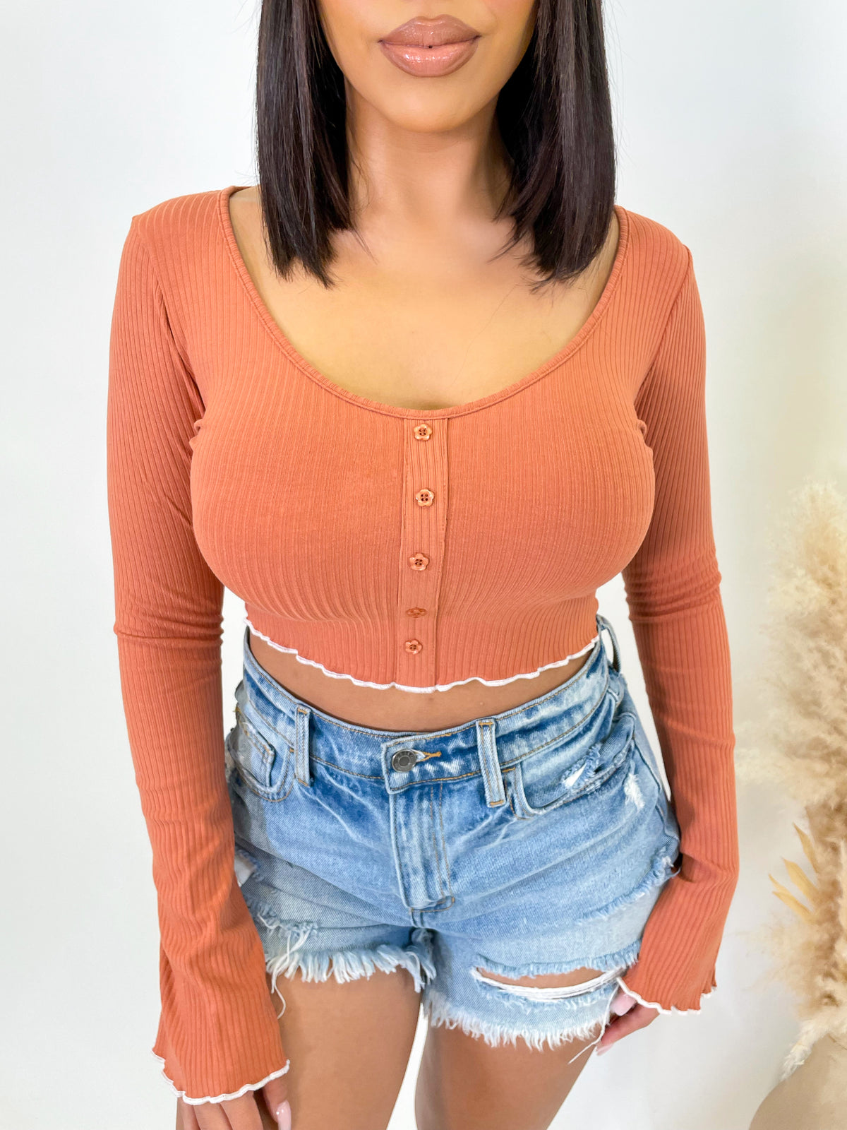 caramel long sleeve top, v neck, white lettuce detailed hem, button down front, ribbed