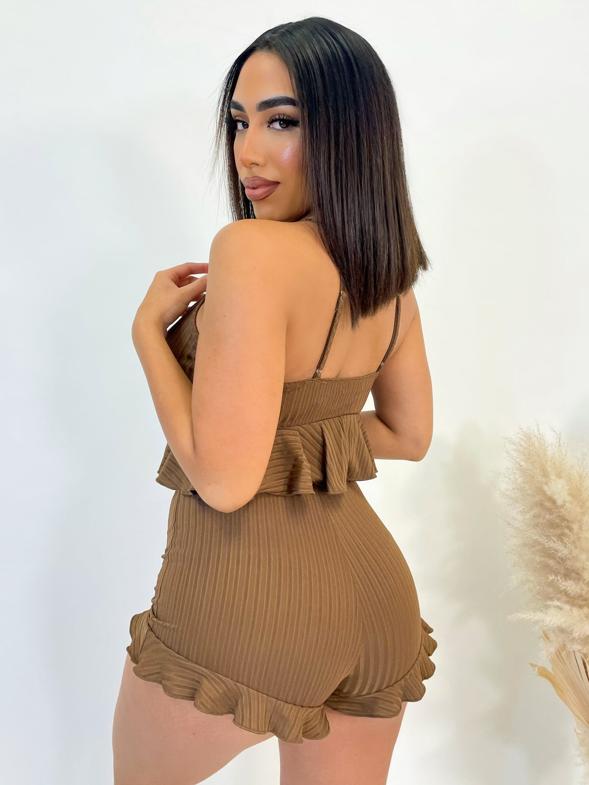 brown 2 piece, crop top, spaghetti straps, adjustable straps, front tie, high waist mini skirt with middle scrunch detail, flared lettuce hem