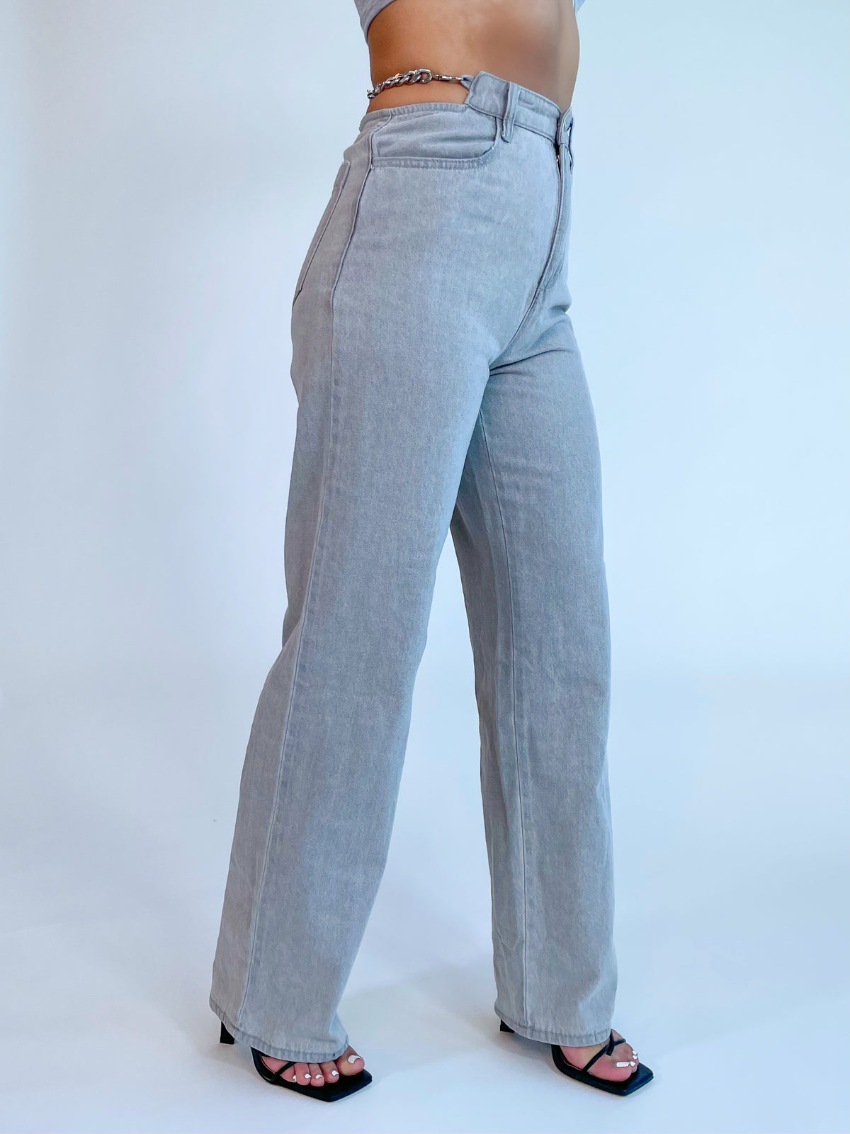 grey straight leg jeans, high waisted, hip cutouts, chain waist detail (on both sides)