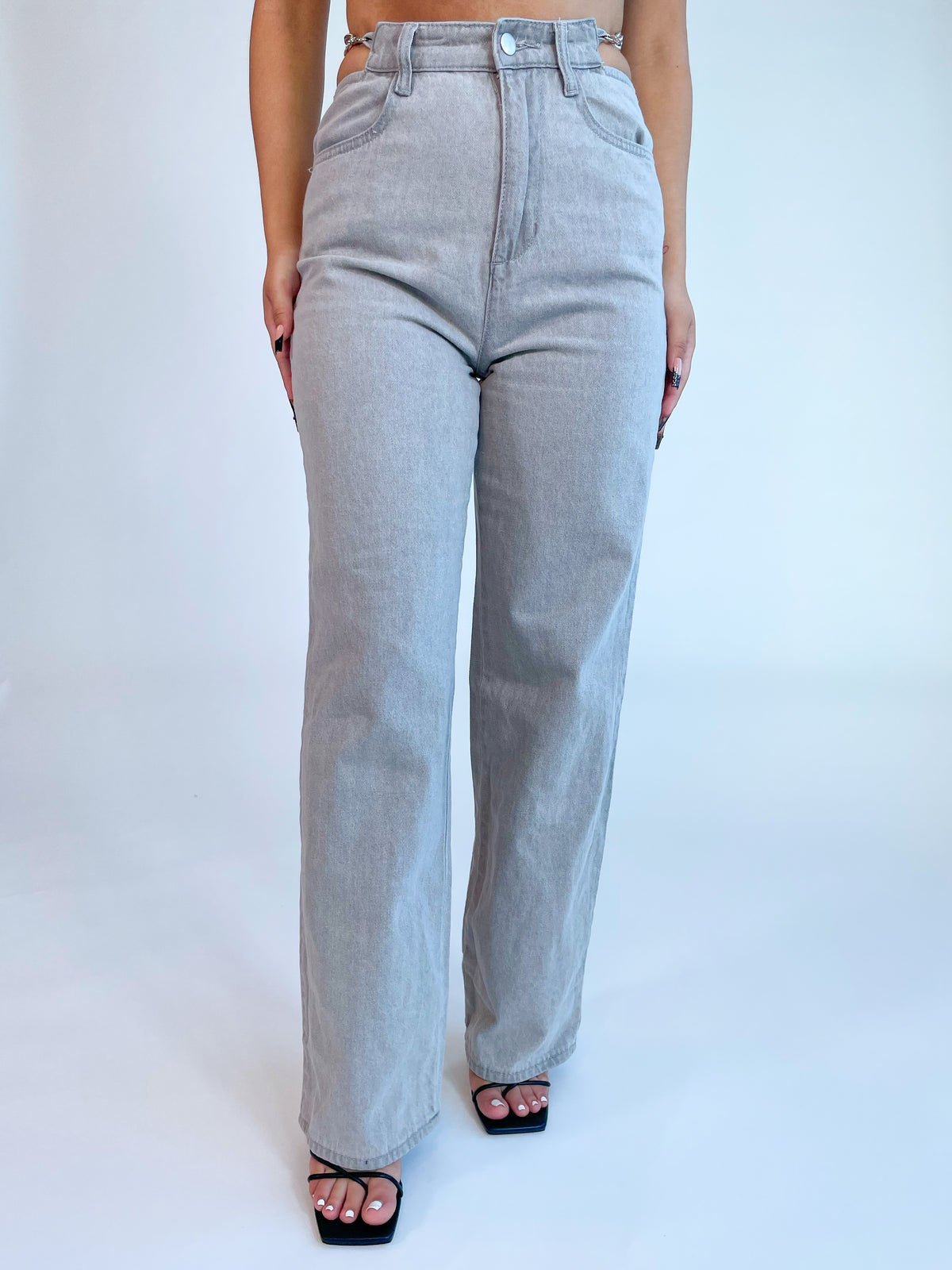 grey straight leg jeans, high waisted, hip cutouts, chain waist detail (on both sides)