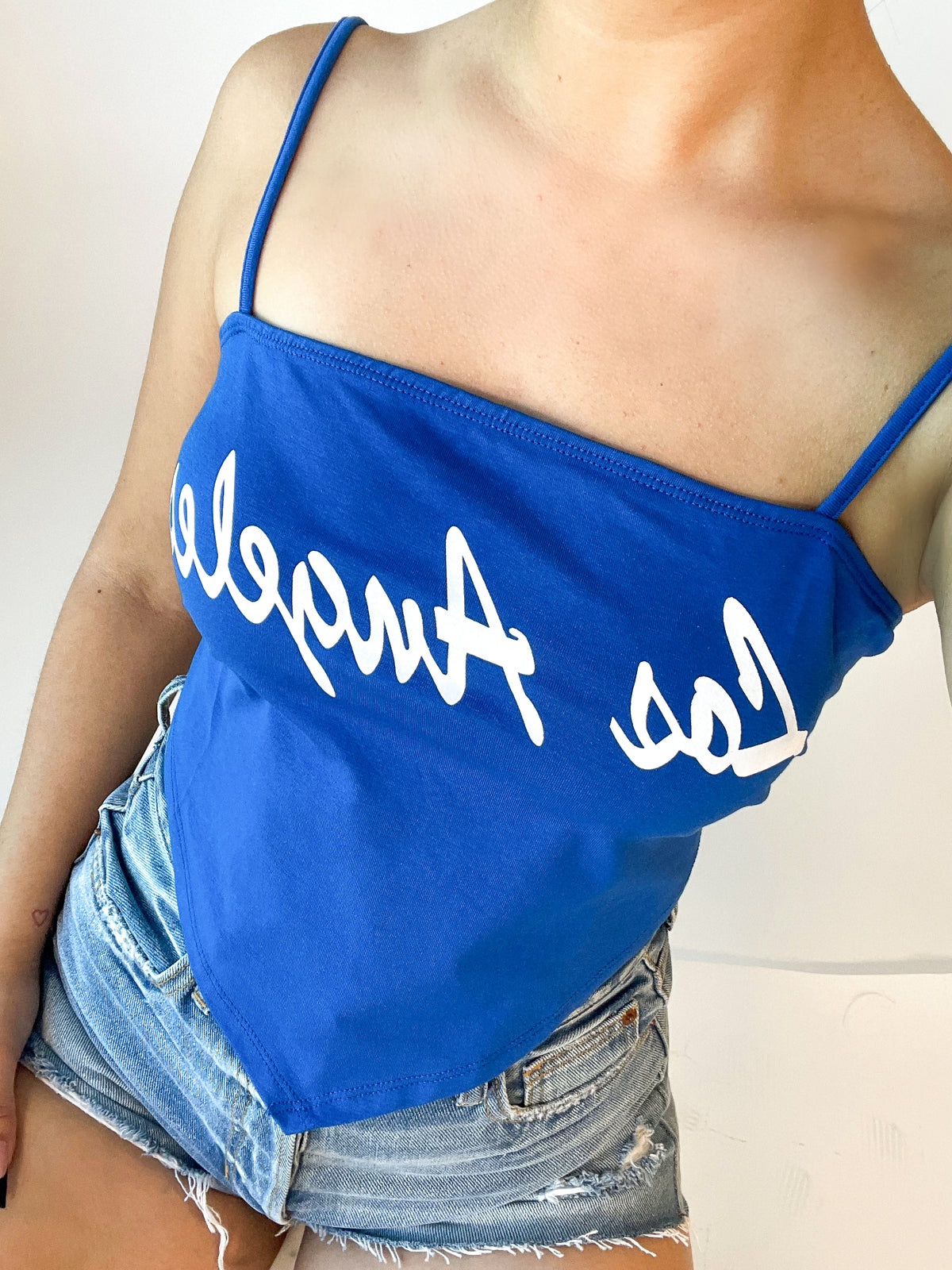 royal blue los angeles top, white font, spaghetti strap, adjustable straps, self tie back, triangle cut out