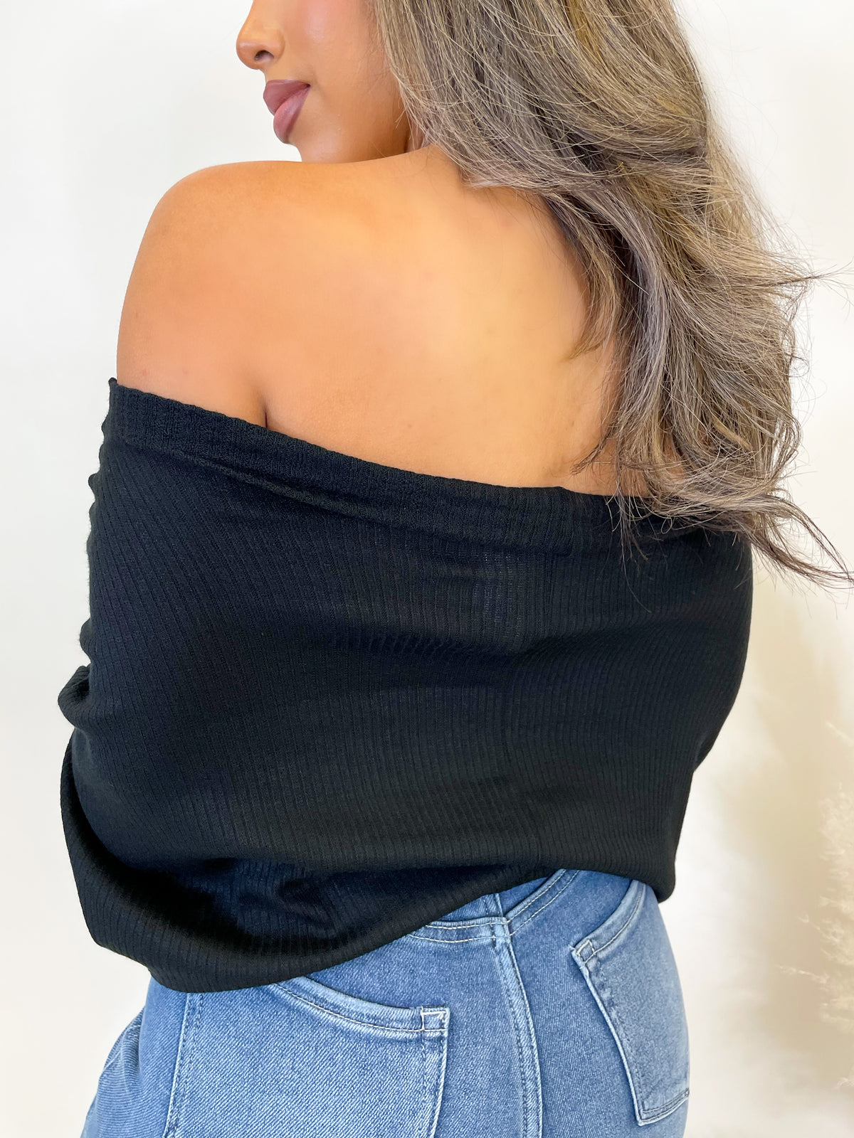  black long sleeve top, ribbed, high neck, droopy neckline