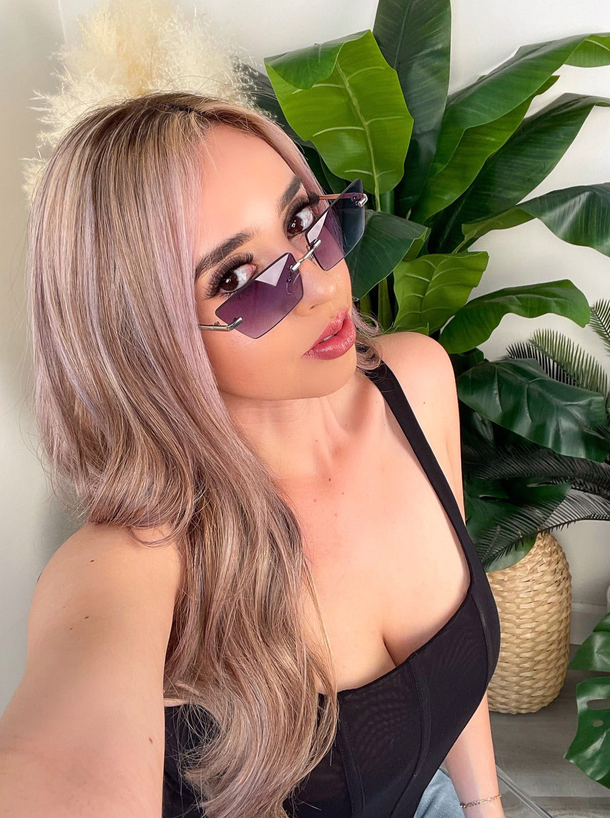 black sunglasses, square at-eye shape, silver nose bridge and arm, dark tint lens