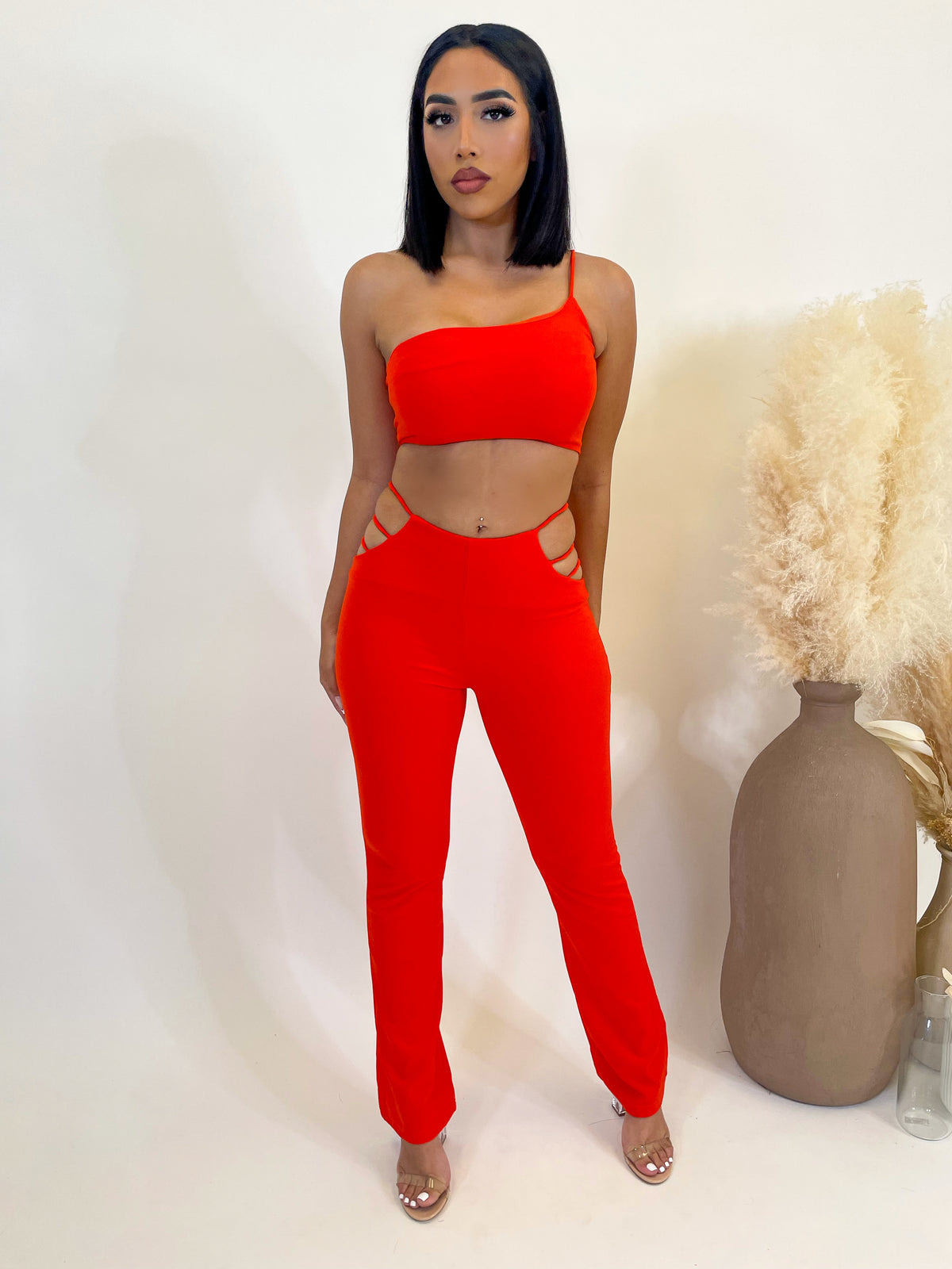 -orange 2 piece  -crop top  -one shoulder  -spaghetti strap  -high waisted pants  -straight leg  -hip cut out detailing