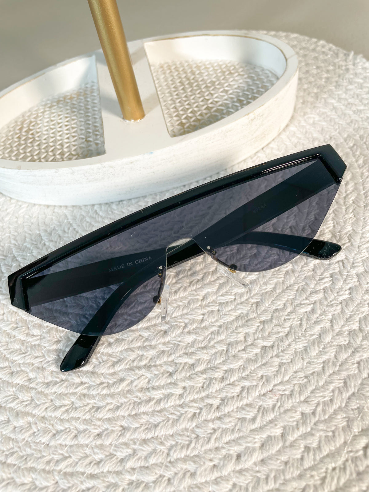 black sunglasses, black frame/arms, light tinted lens